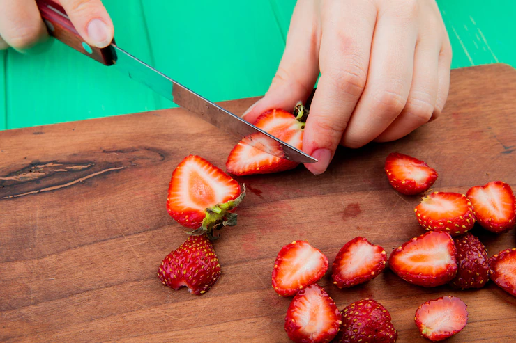 Cut the Tops off the Strawberries and Slice Them Into a Few Pieces